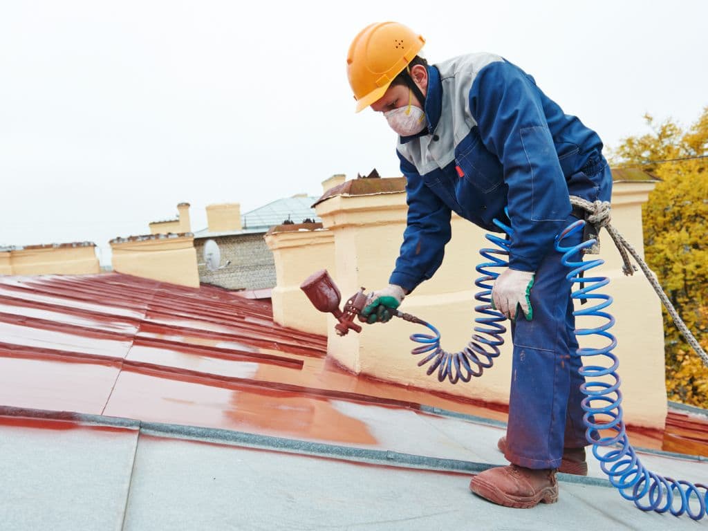 Roofers Spray Painting Metal Roof in Fort Lauderdale FL